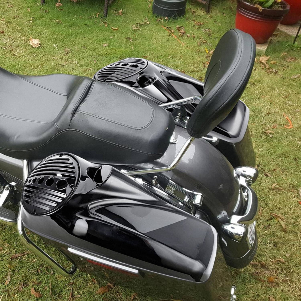 Black speaker lids on motorcycle, side close-up showing grille vents