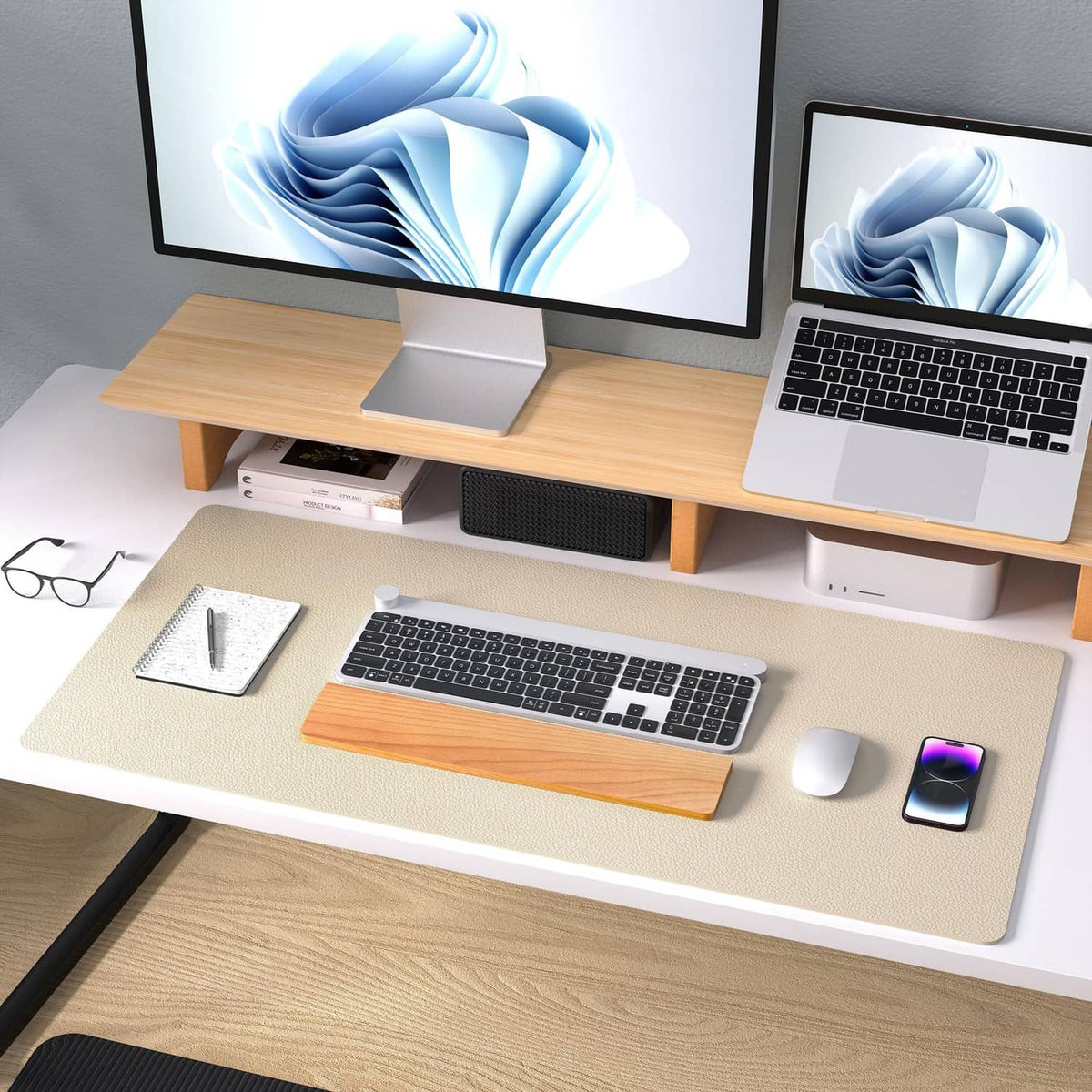 Beige leather desk pad protector on desk with laptop, mouse, and phone