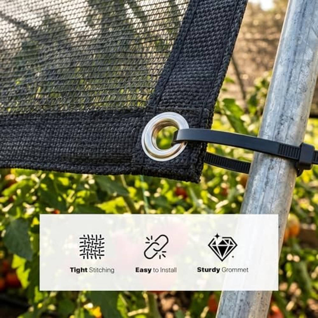 Black shade cloth corner secured to a post with strap and metal grommet