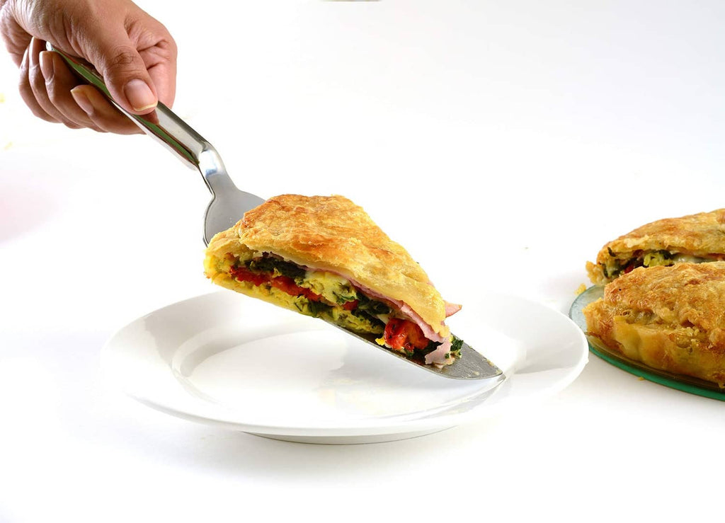 Norpro stainless steel spatula lifting a slice from a plate, wide angled blade