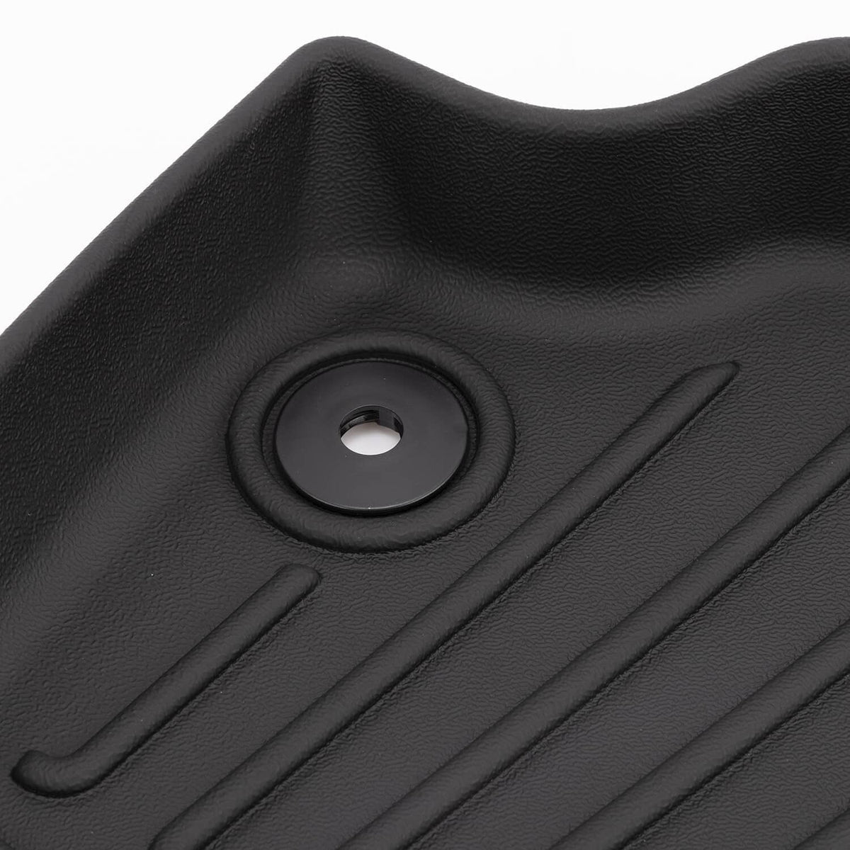 Black rubber floor mat texture with circular grommet hole