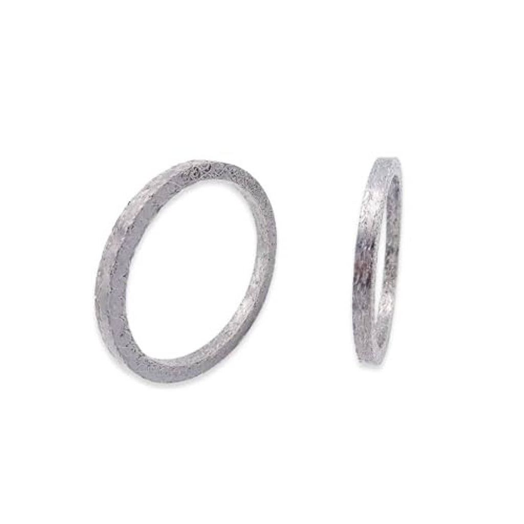 Exhaust port gasket kit with two gray steel mesh gasket rings, one side view