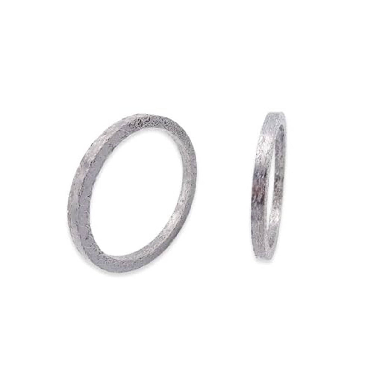 Exhaust port gasket kit with two gray steel mesh gasket rings, one side view