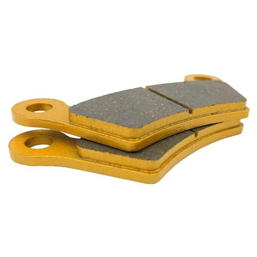 Ceramic brake pads stacked, gray friction surface with yellow backing and mounting holes