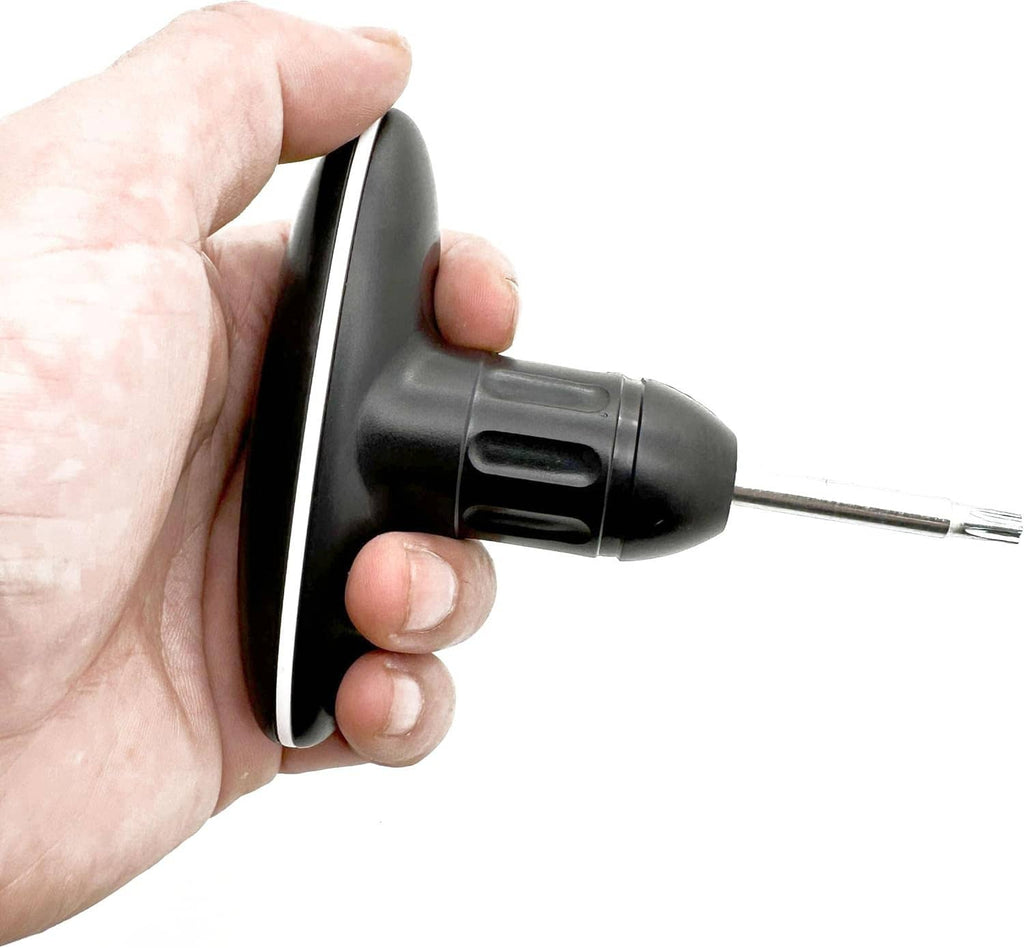 Golf torque wrench grip held in hand with metal shaft and star-shaped tip