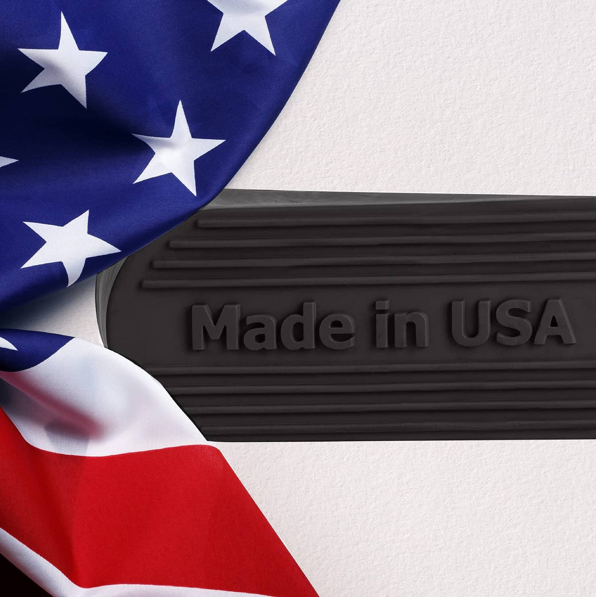 Black rubber door stopper with embossed 'Made in USA' on top surface