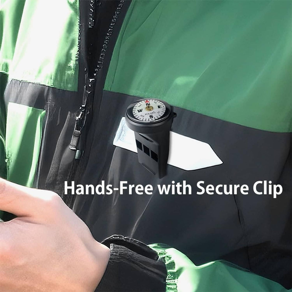 Micro compass clipped to a green jacket front strap with visible white compass face