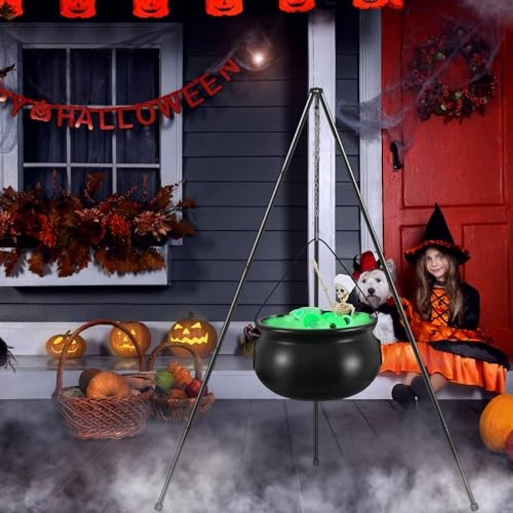 Outdoor witch cauldron on tripod stand with green glow for Halloween porch decor