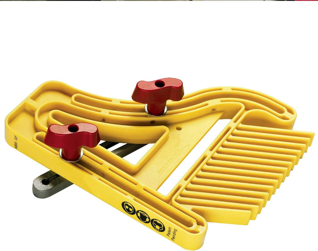 Yellow push block with curved burgundy clamps on a base