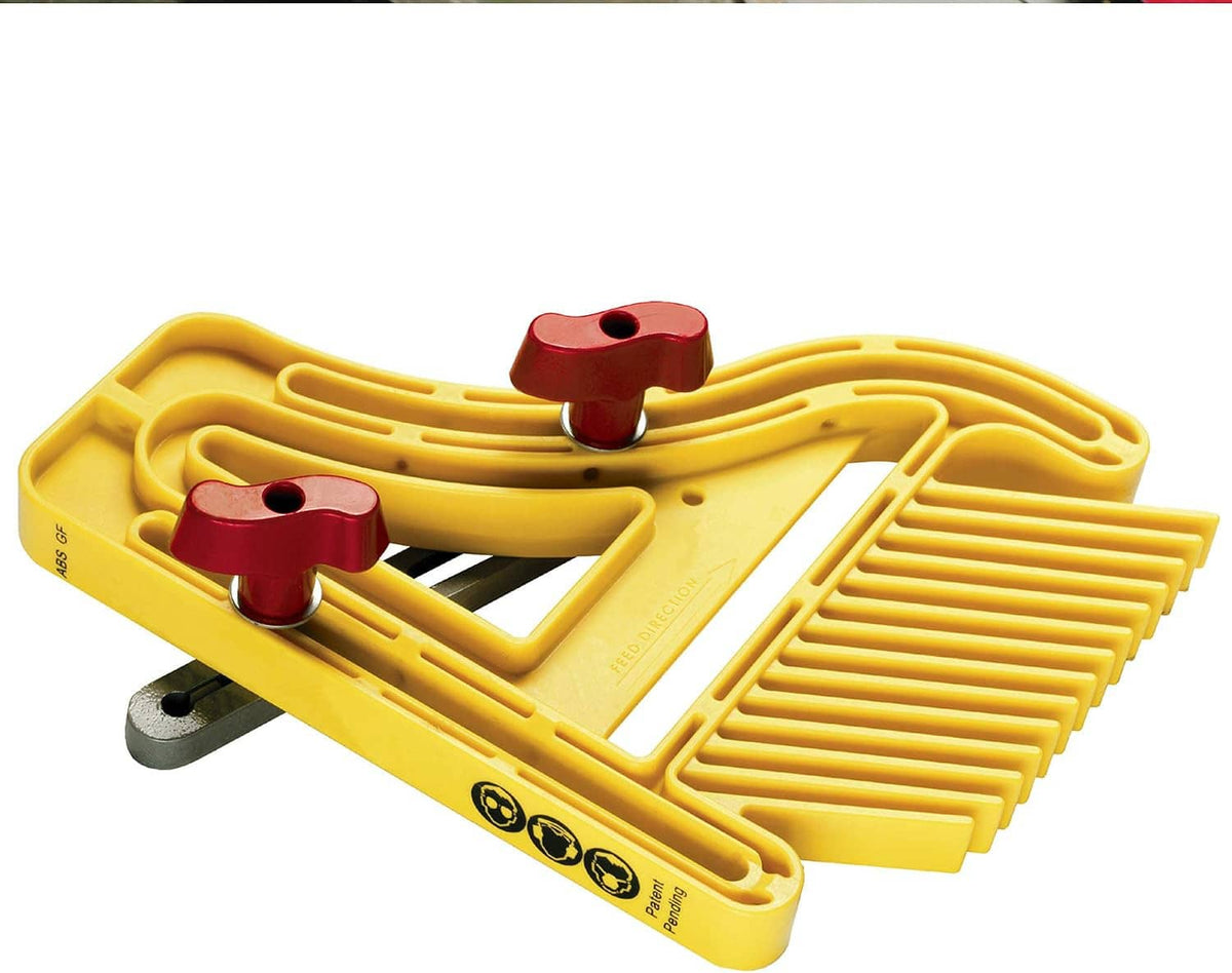 Yellow push block with curved burgundy clamps on a base