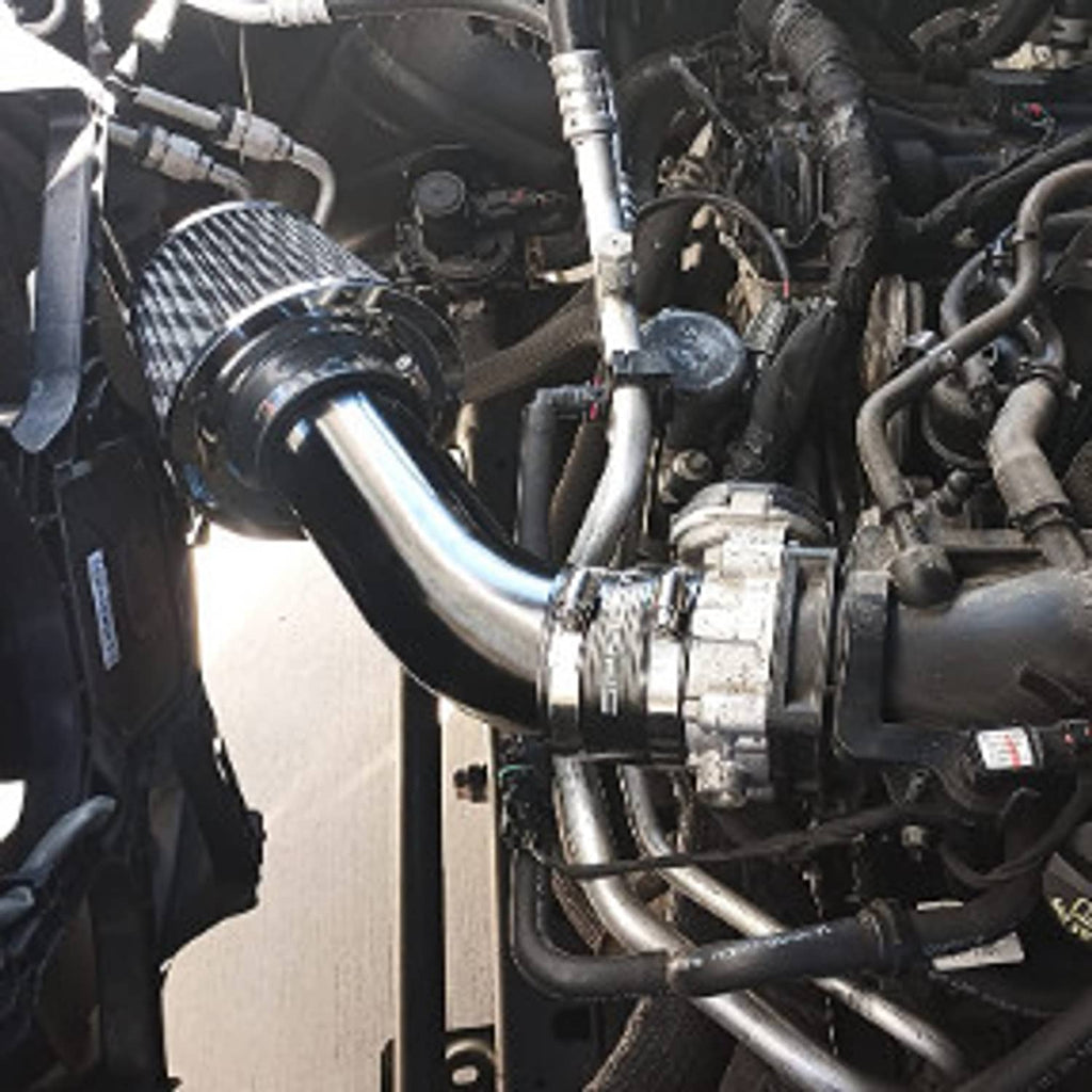 Engine bay view of cold air intake piping with black filter and connected hoses