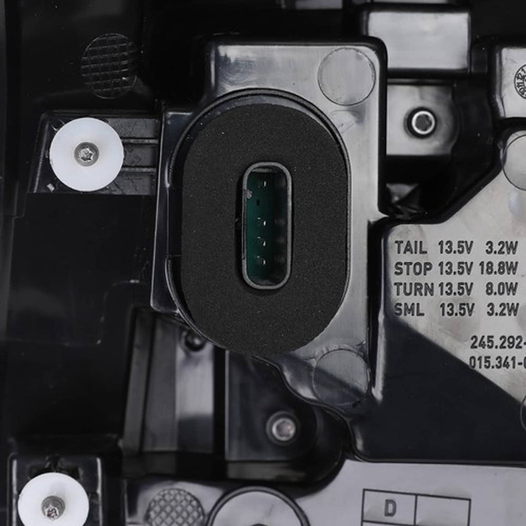 Tail light electrical connector port with green terminals and wiring housing.