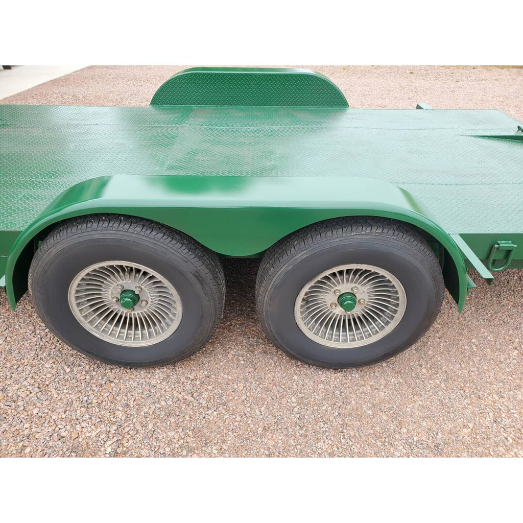 Front view of two silver steel trailer fenders with teardrop curved arch profile