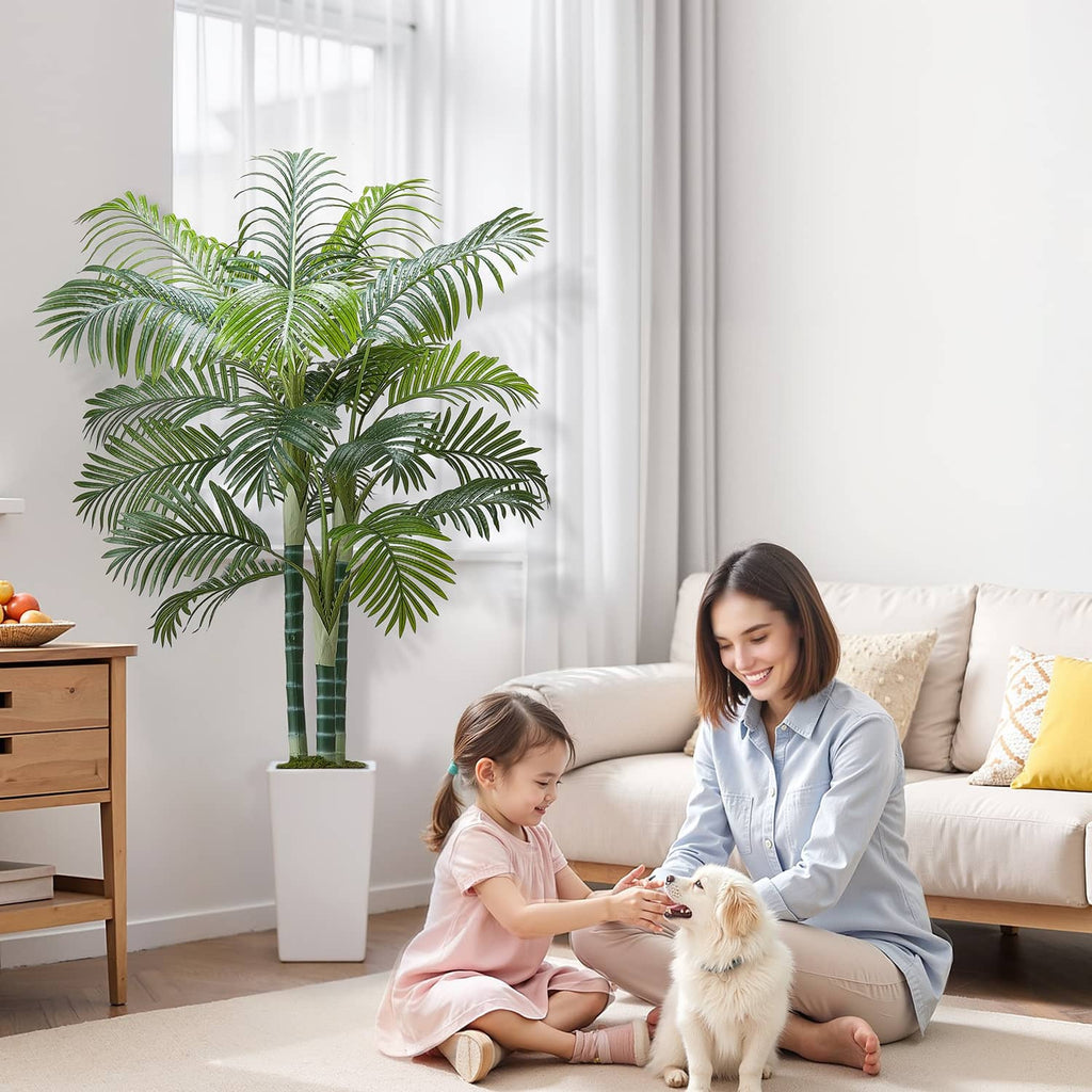 Faux palm tree with green leaf fronds in white pot for indoor spaces