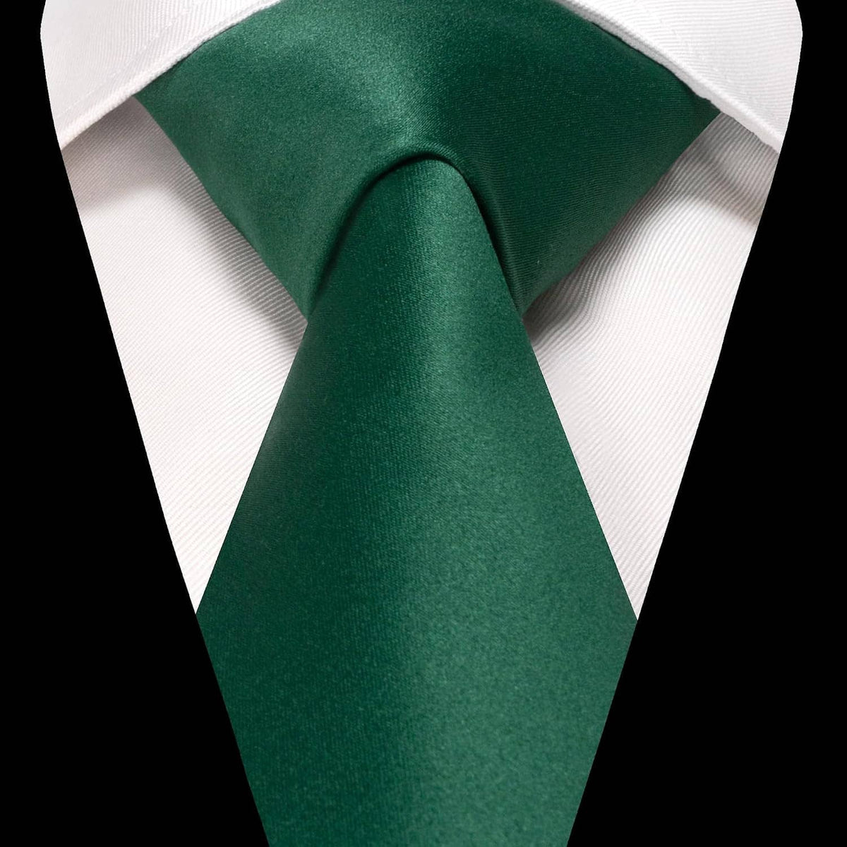 Solid dark green necktie shown against a white shirt collar; pocket square