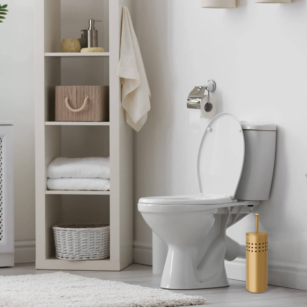 Gold toilet plunger with holder placed next to a white toilet
