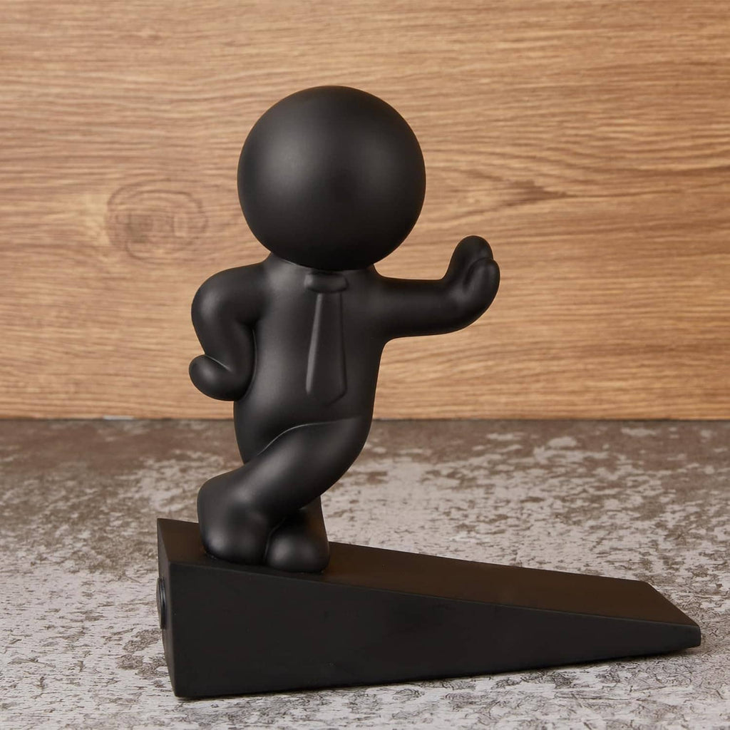 Matte black seated man figurine door stop with wedge base and raised arm