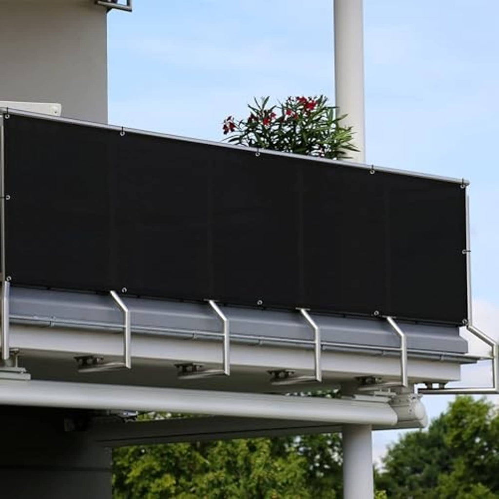 Black privacy screen panel with metal grommets mounted to a balcony railing