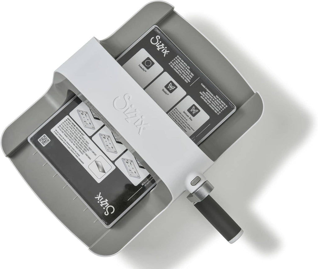 Gray and white Sizzix Big Shot die-cutting machine with visible labels