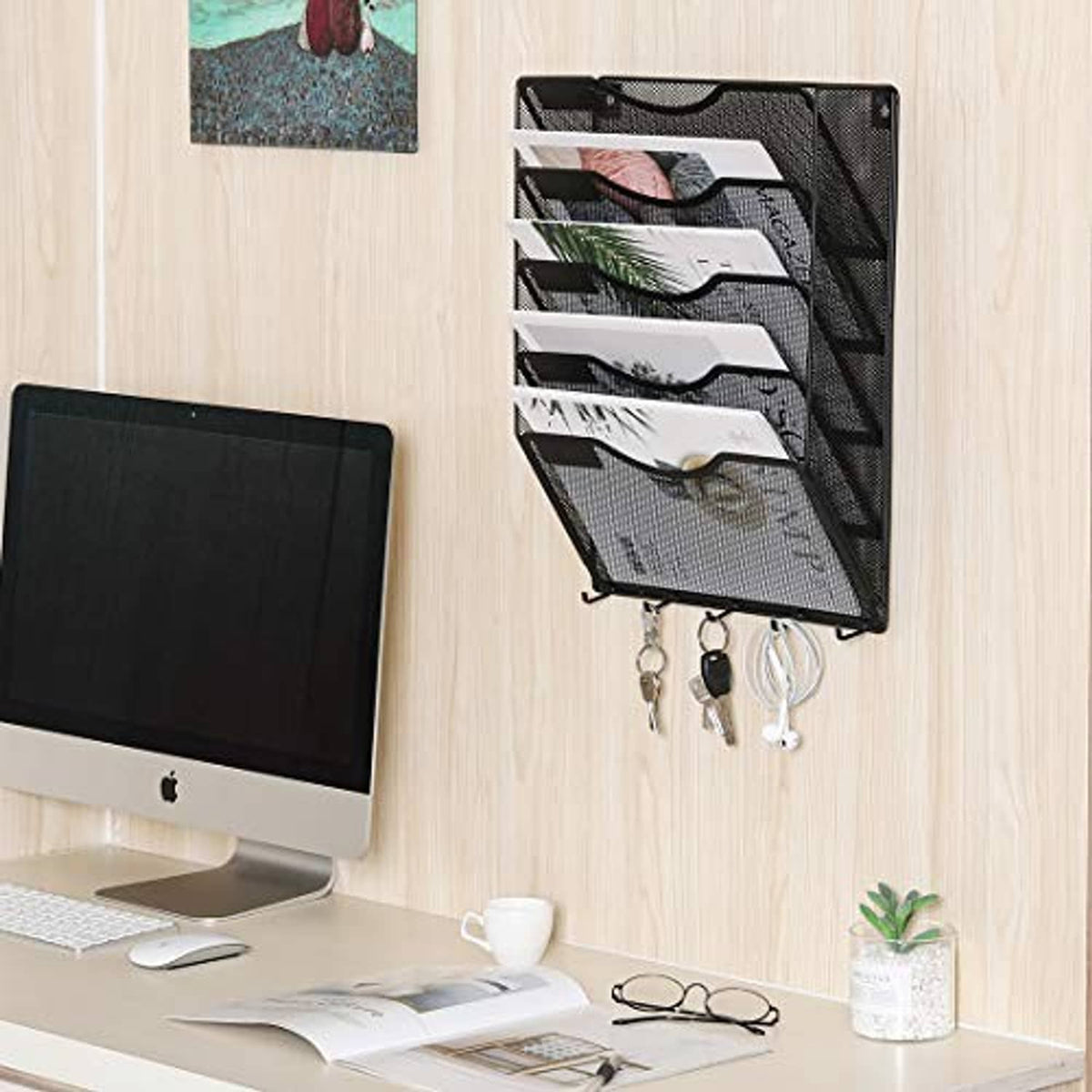 Wall-mounted black mesh file organizer with 5 pockets and four keys hanging from hooks