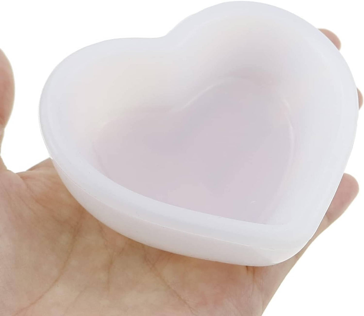 White heart-shaped resin mold bowl held in a hand