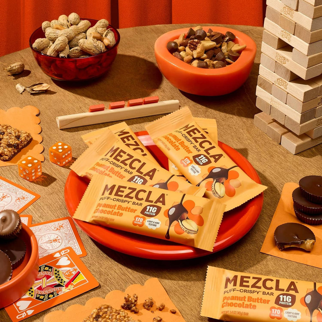 Plant-based protein bar packs on a plate with whole peanut butter chocolate bars