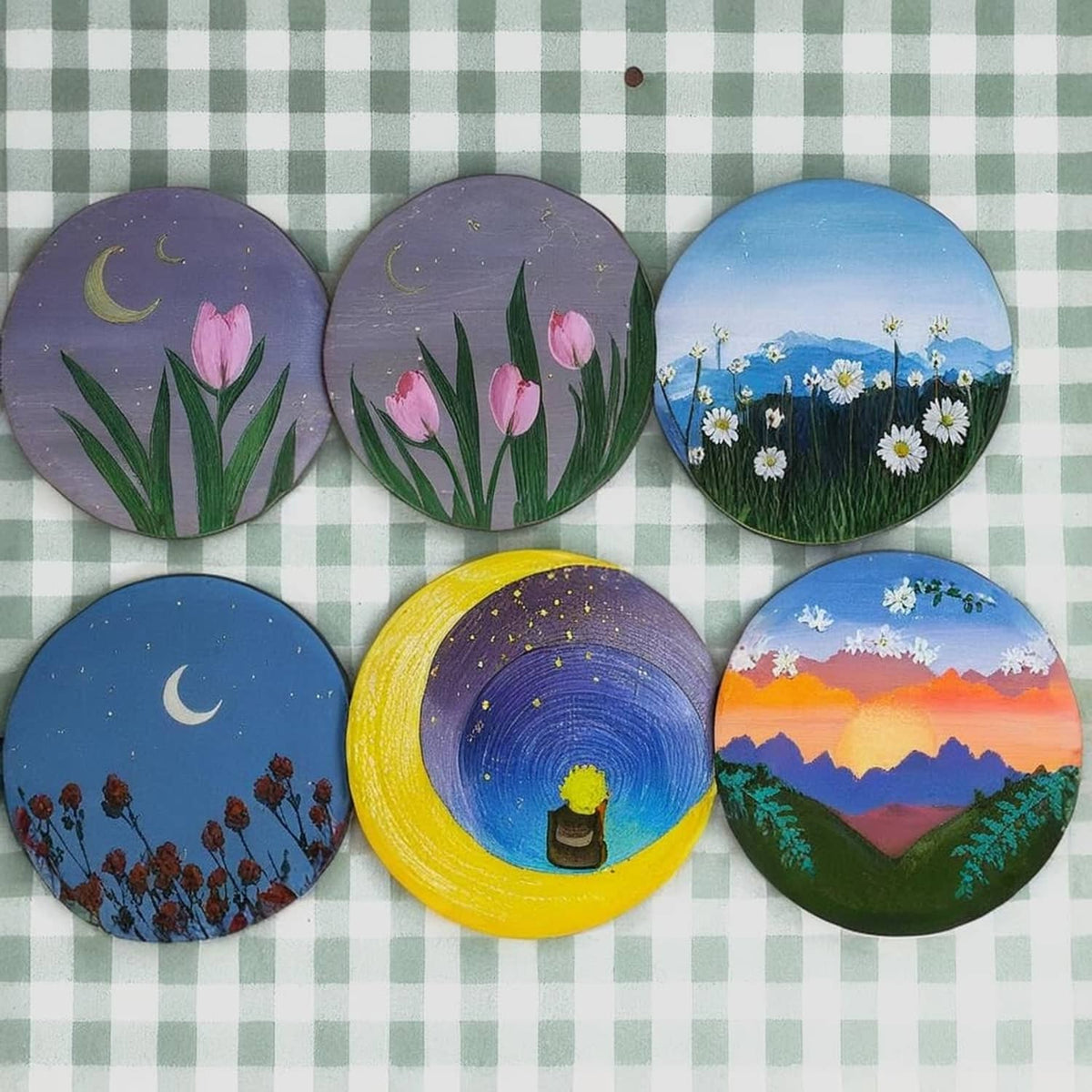 Painted round wood slice set with floral, moon, and landscape designs