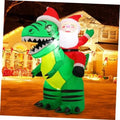 Inflatable Santa riding green cartoon crocodile with red Santa hat and white beard