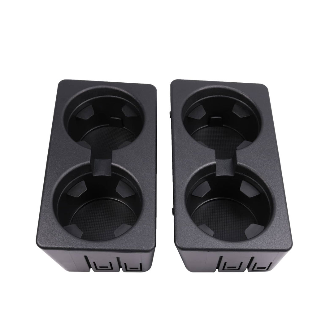 Pair of black cup holder openings with molded grips and front slot details