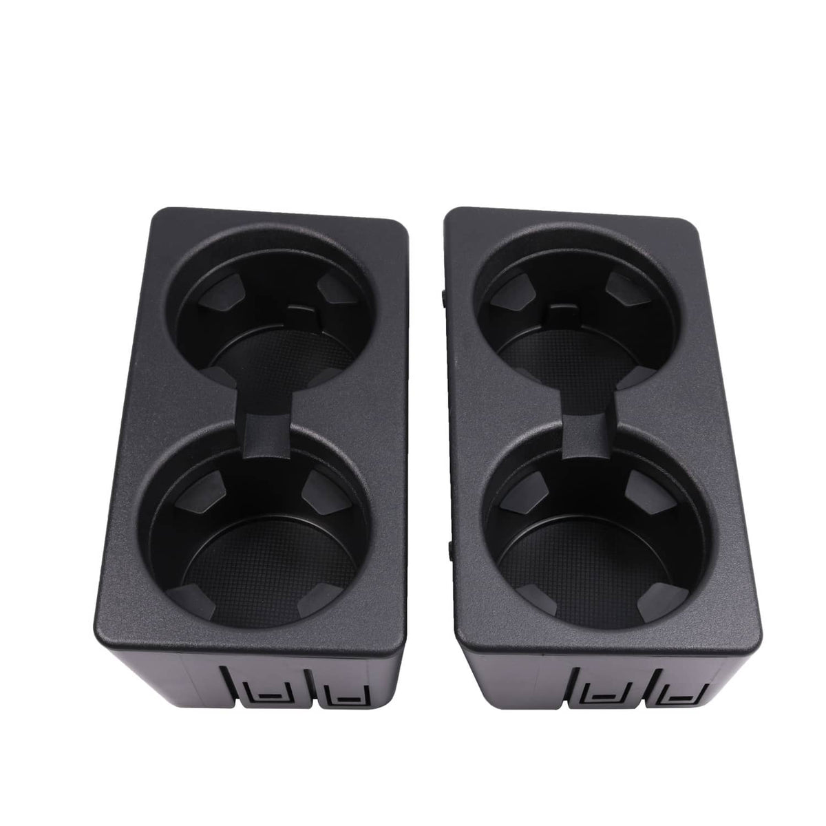 Pair of black cup holder openings with molded grips and front slot details