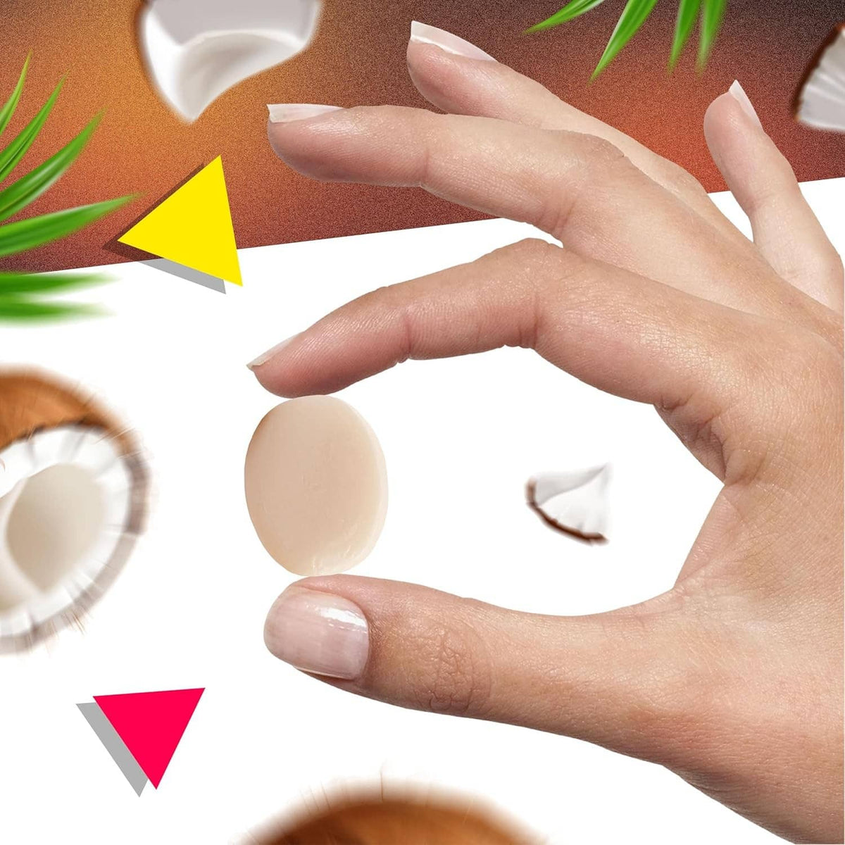 Hand holding a coconut-filled hard candy with coconut shell pieces