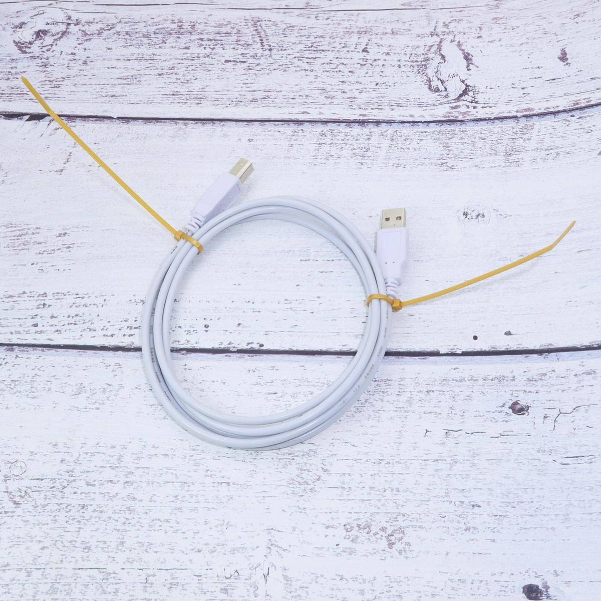 Gold nylon zip cable ties securing white cables, 6-inch style