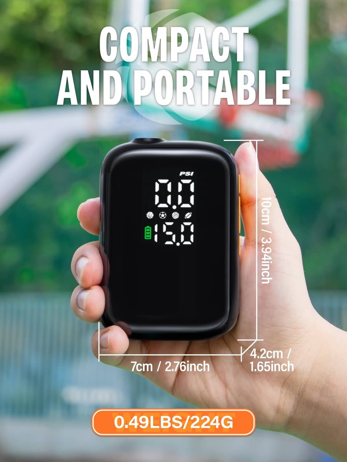 Black portable mini ball pump held in hand with digital PSI display