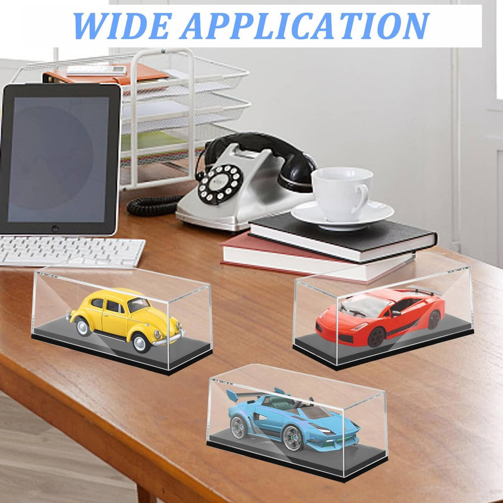 Crystal clear cubed display cases with dark bases for 1/64 model cars on a desk