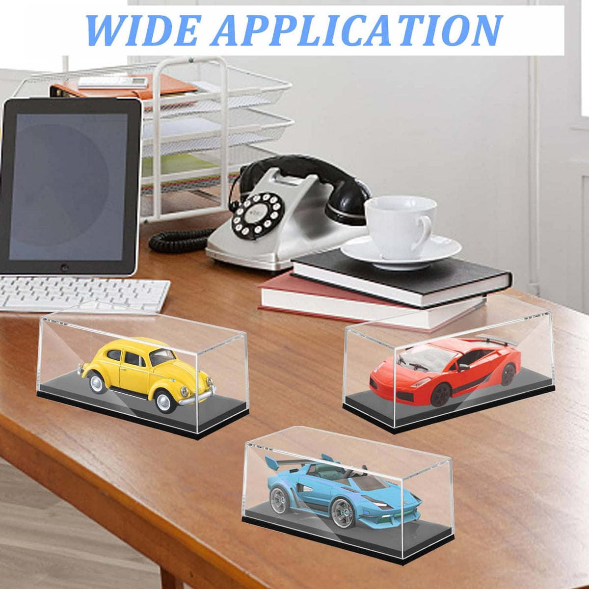 Crystal clear cubed display cases with dark bases for 1/64 model cars on a desk