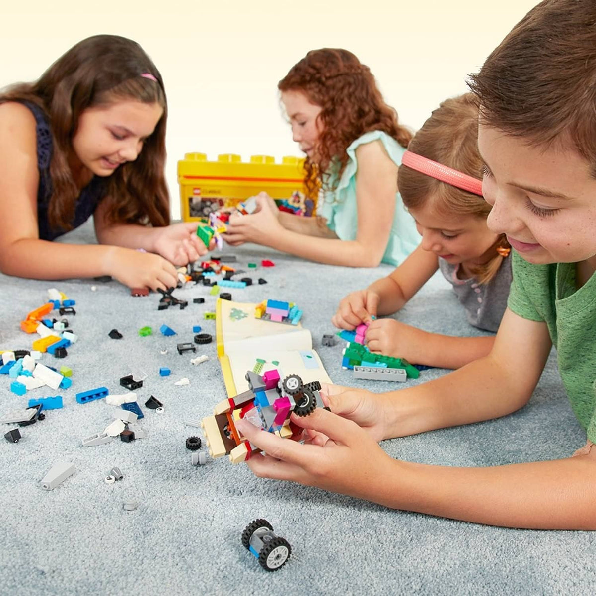 LEGO bricks set with small builds on play mat during assembly