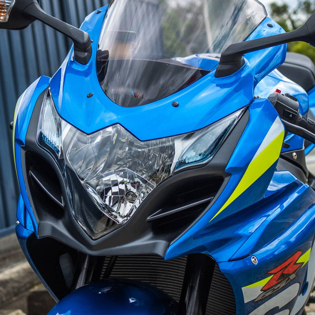 Motorcycle headlight assembly with clear lens and chrome reflectors, installed