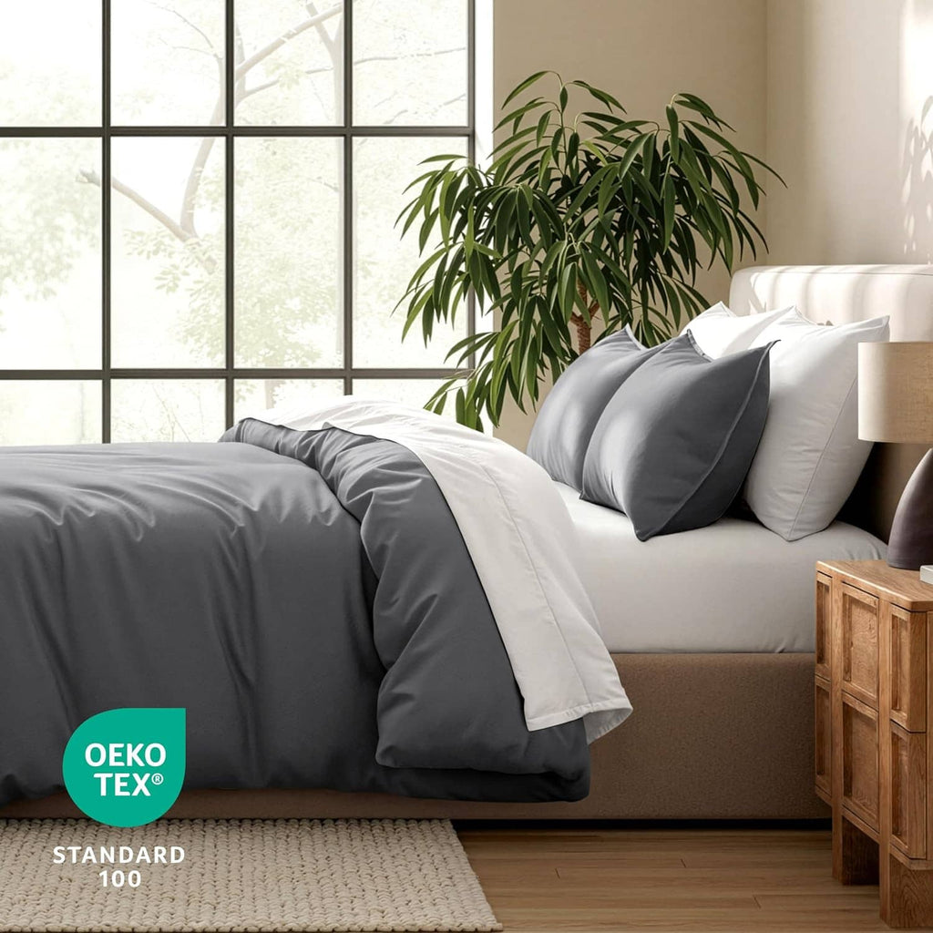 Dark gray duvet cover on queen bed with pillow shams, crisp layered look.