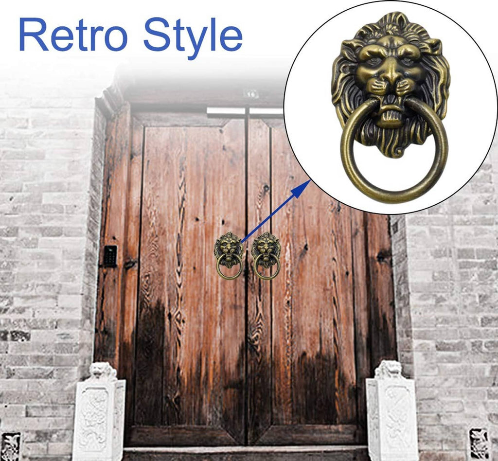 Bronze lion head cabinet knob pulls with ring handles mounted on a wooden door
