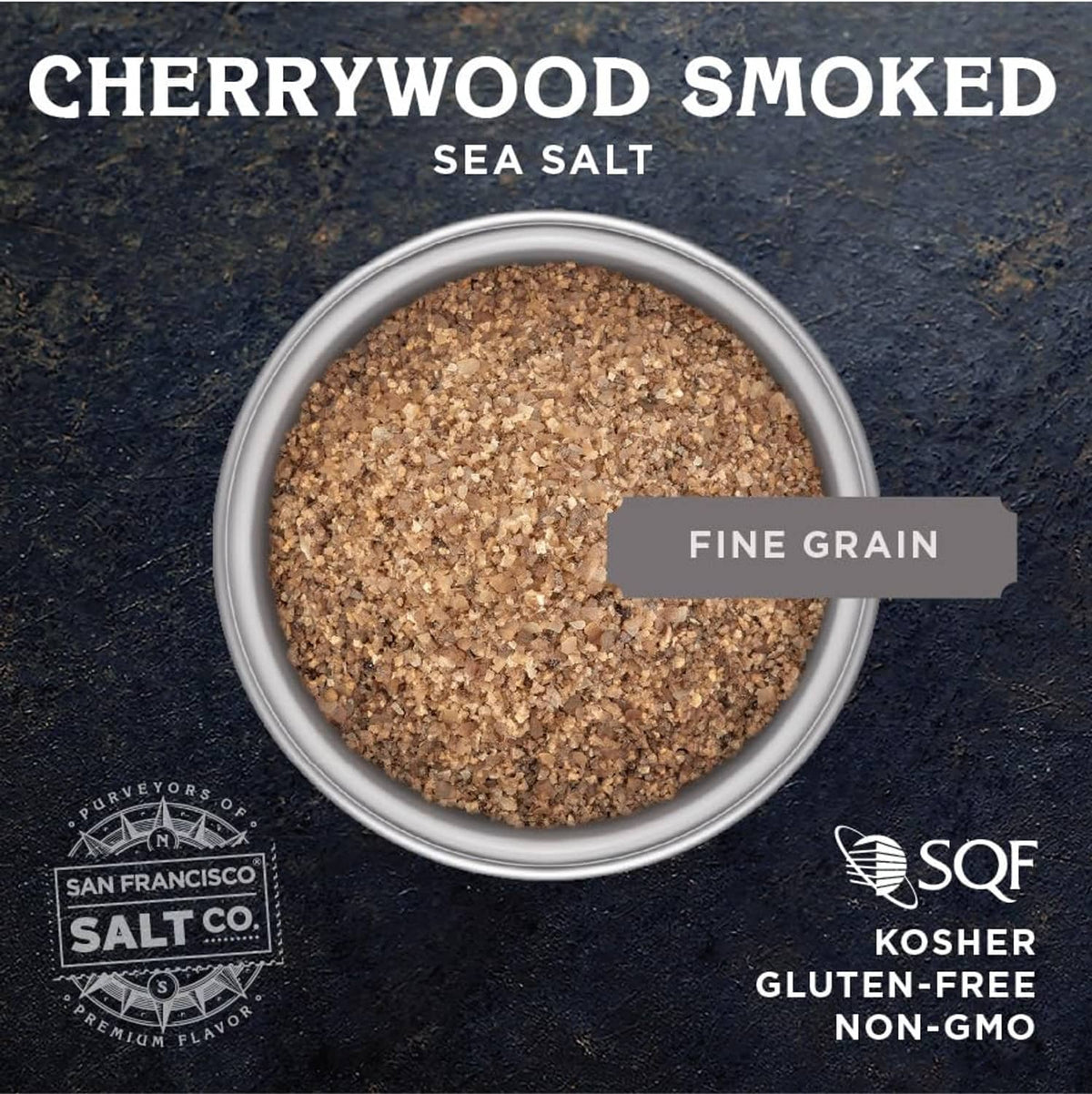 Small bowl of cherrywood smoked sea salt, fine grain, dark brown speckled texture