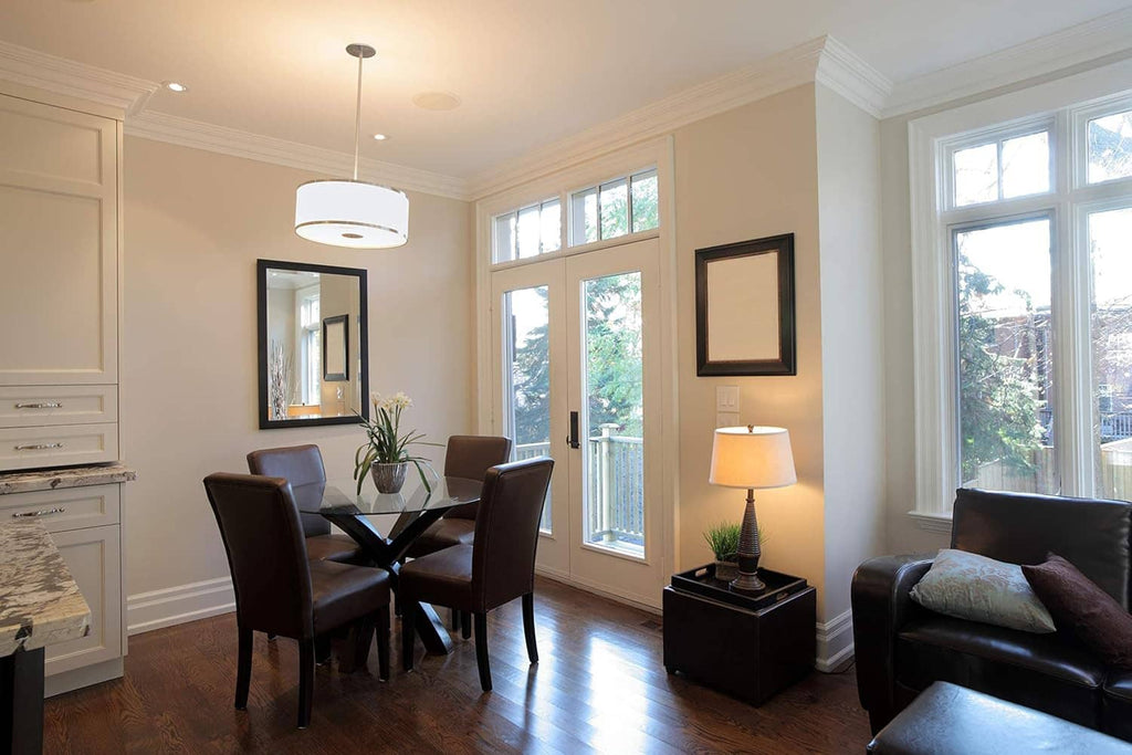 Living room interior with dining set, windows, and lamps