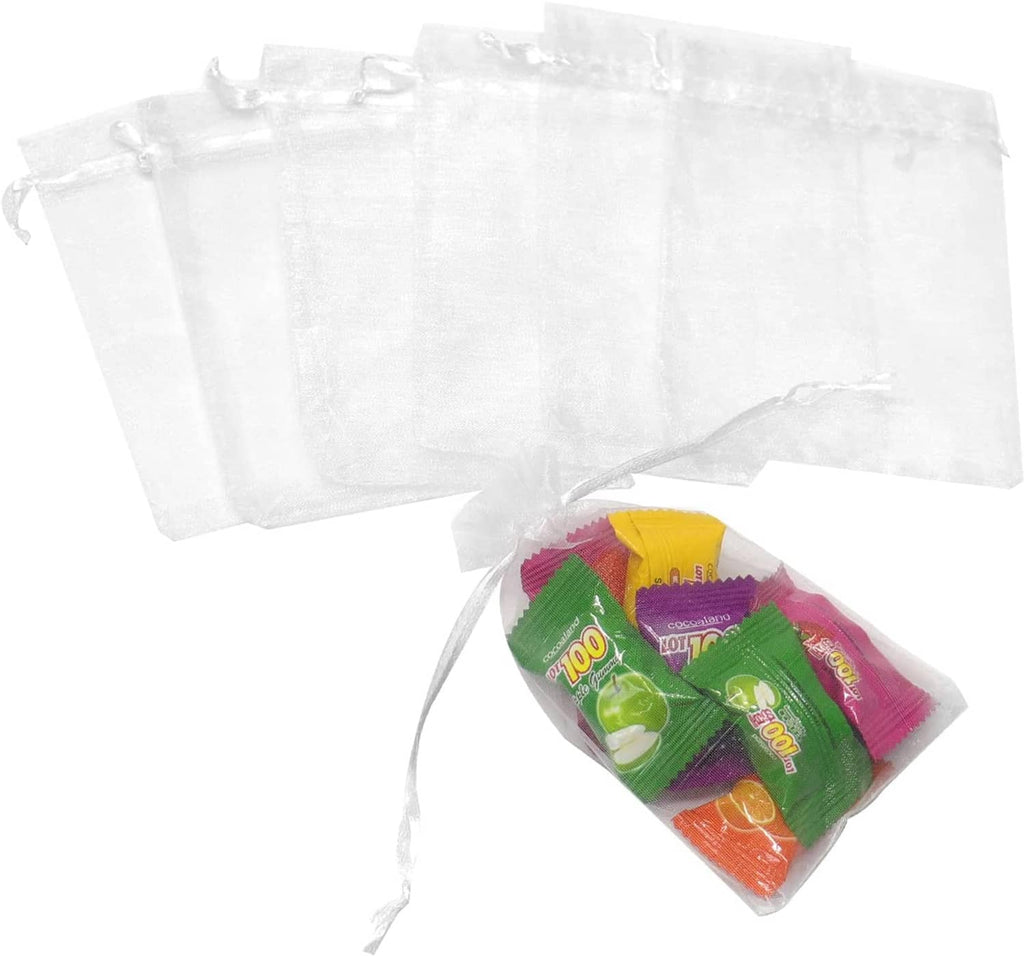 Set of white organza drawstring bags, one pouch filled with small packaged sweets
