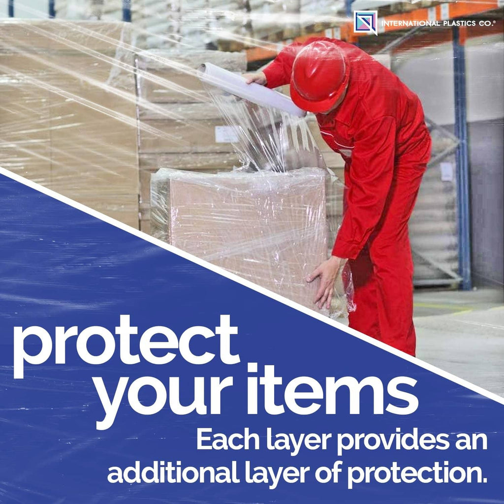 Warehouse worker applying clear plastic stretch wrap to stacked boxes
