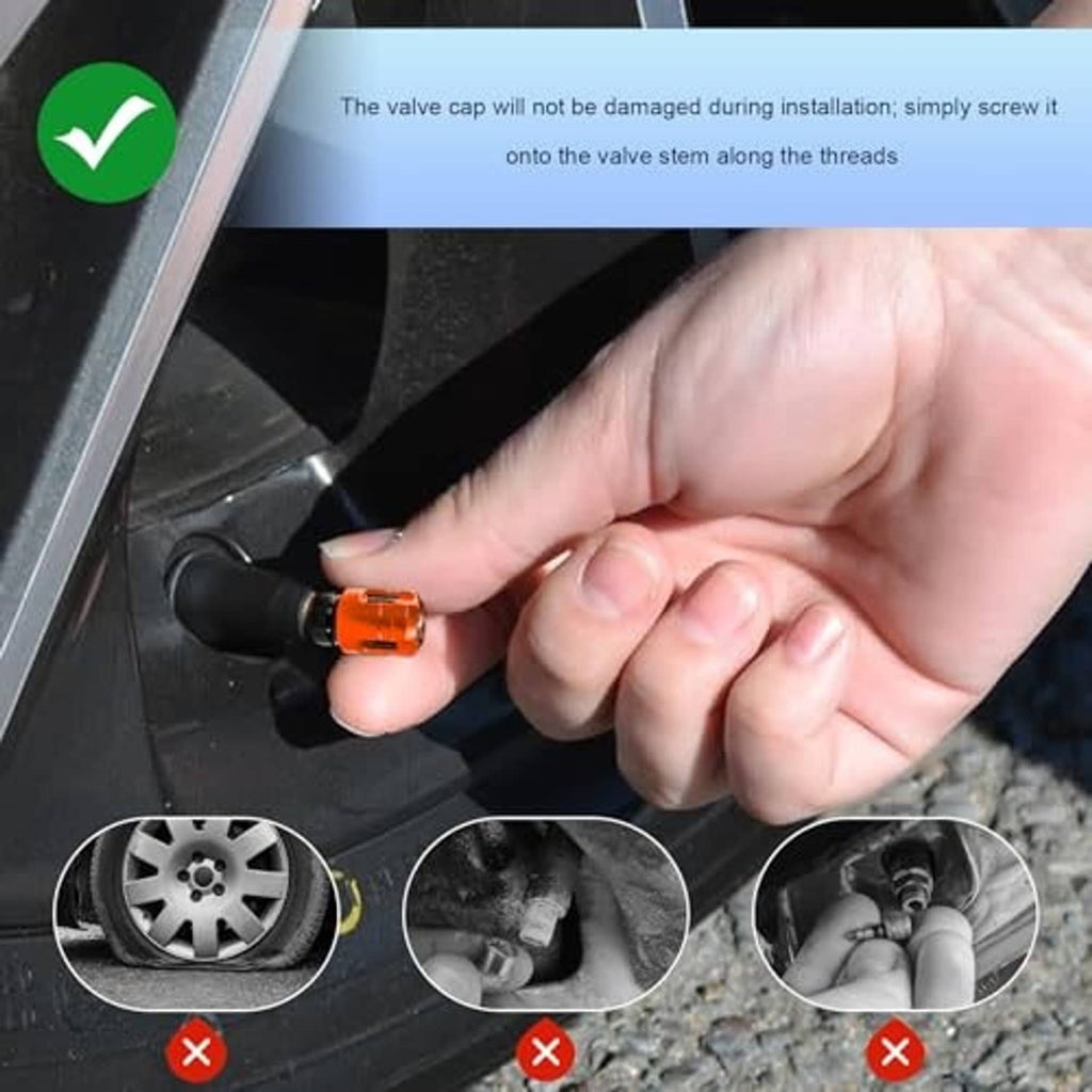 Hand installing an orange tire valve stem cap onto a black valve stem