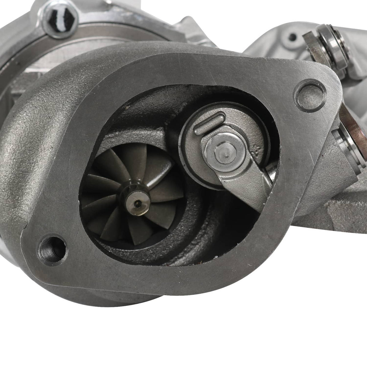 Turbocharger compressor housing close-up with black impeller and mounting bolts