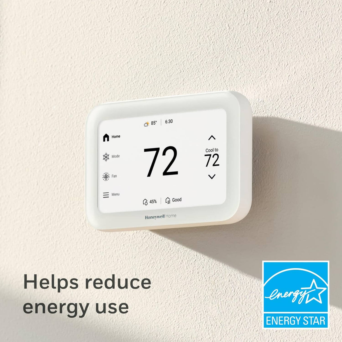 White smart thermostat on wall with large digital temperature display