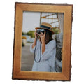 Rustic live-edge wood picture frame with brown border and clear glass opening