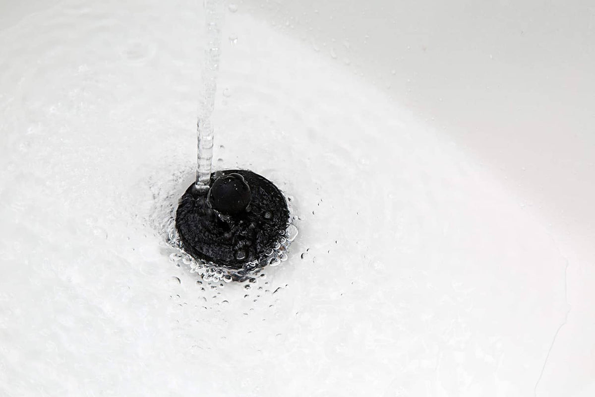 Black universal bathtub stopper plug in tub drain opening, two-pack