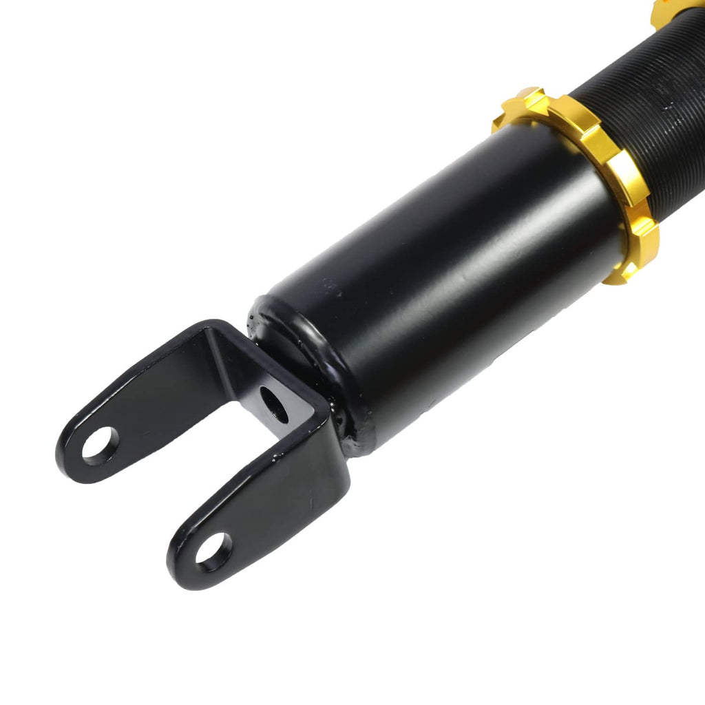 Close-up coilover shock strut with black body, gold collar, and mounting bracket