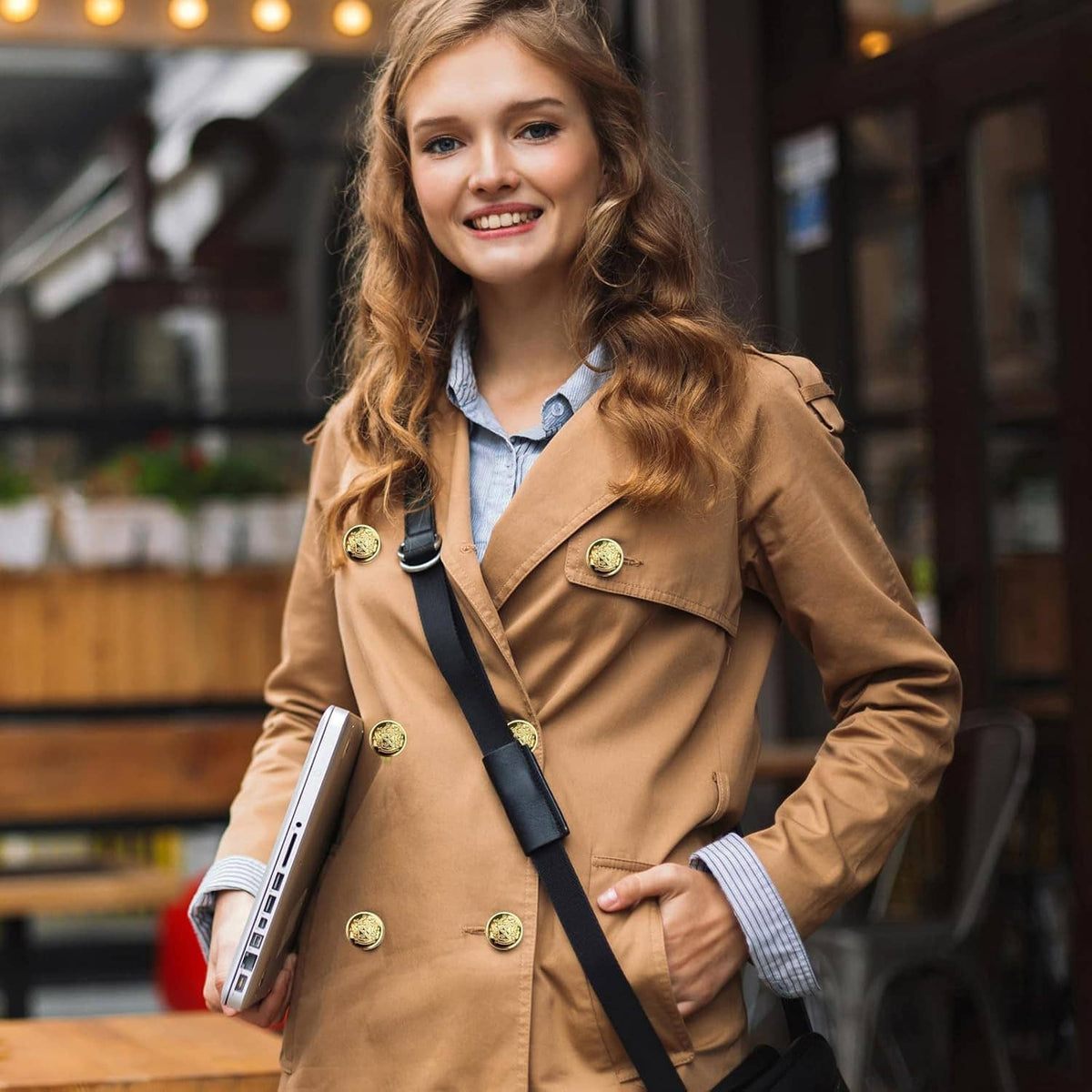 Tan blazer with round gold crest buttons on front placket, worn on model